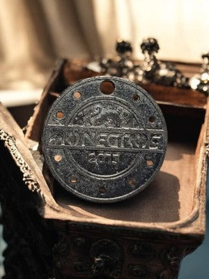 Vintage metal casino token MONÉGROS 2015, round holed coin, old token
