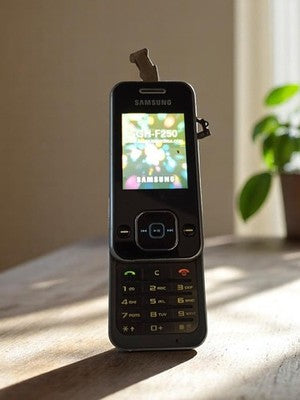 Téléphone Samsung SGH-F250 vintage rétro coulissant sans chargeur fonctionnel