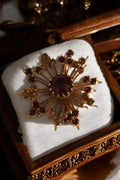 Broche vintage dorée années 60 strass rouges et ambre style étoile rétro
