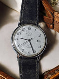 Montre femme Elvia Paris quartz ancien cadran blanc dateur vintage