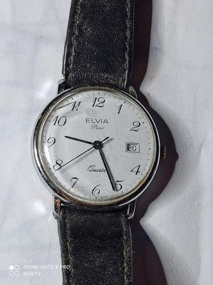 Montre femme Elvia Paris quartz ancien cadran blanc dateur vintage