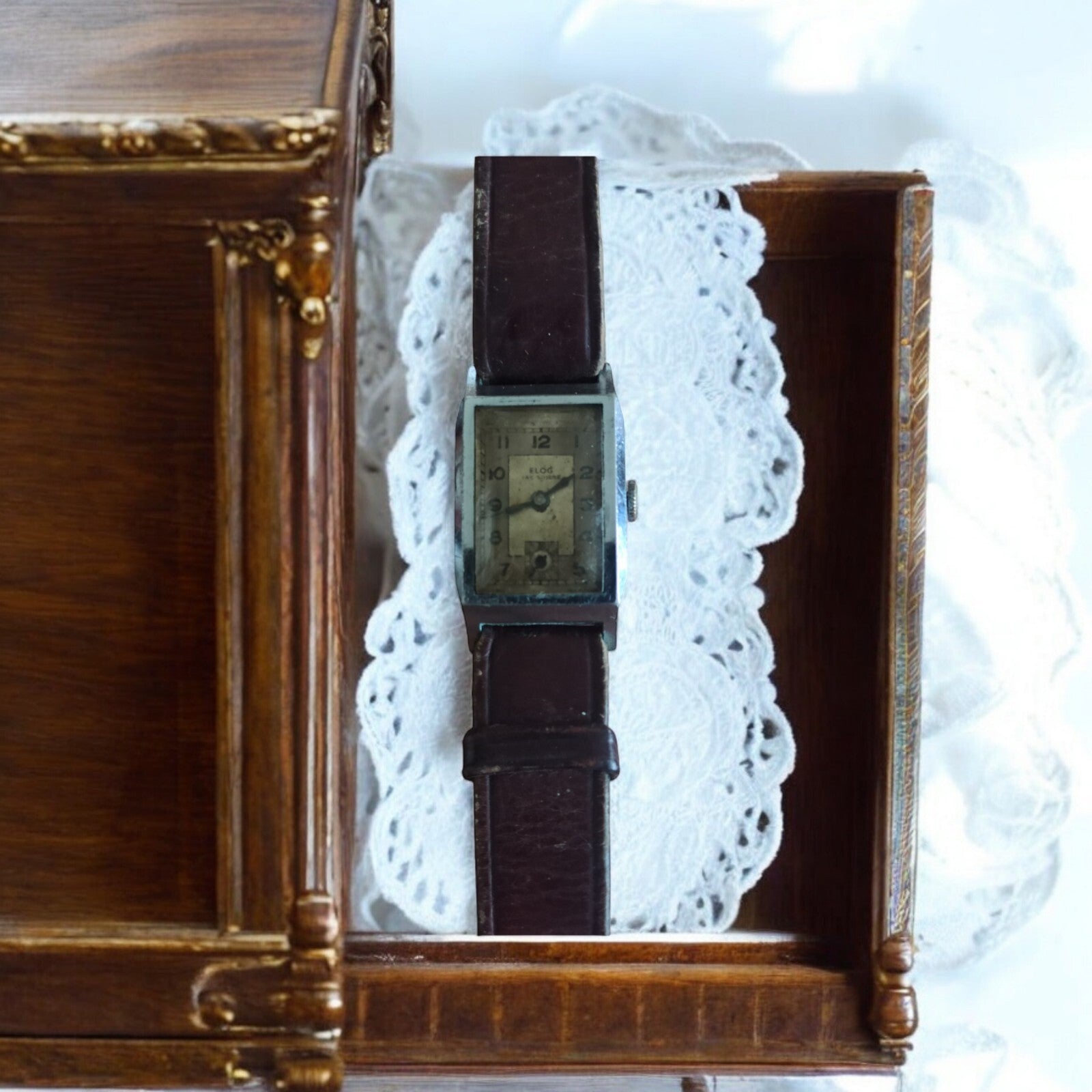 Montre rectangulaire vintage Elog Suisse mécanique cadran patiné, bracelet brun