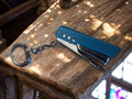 Porte-clés vintage agrafeuse métal bleu publicitaire France rétro