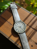 Montre homme vintage cadran chiffres romains gris rétro non testée
