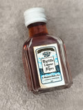 Mini-bouteille Myrtille Liqueur des Alpes A. Meunier Fils partiellement remplie