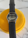 Montre vintage OLITEC homme, cadran graphique noir, bracelet aspect cuir