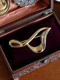 Élégante broche vintage plaquée or
