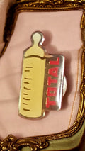 Pin's publicitaire vintage TOTAL biberon jaune, badge ancien années 90