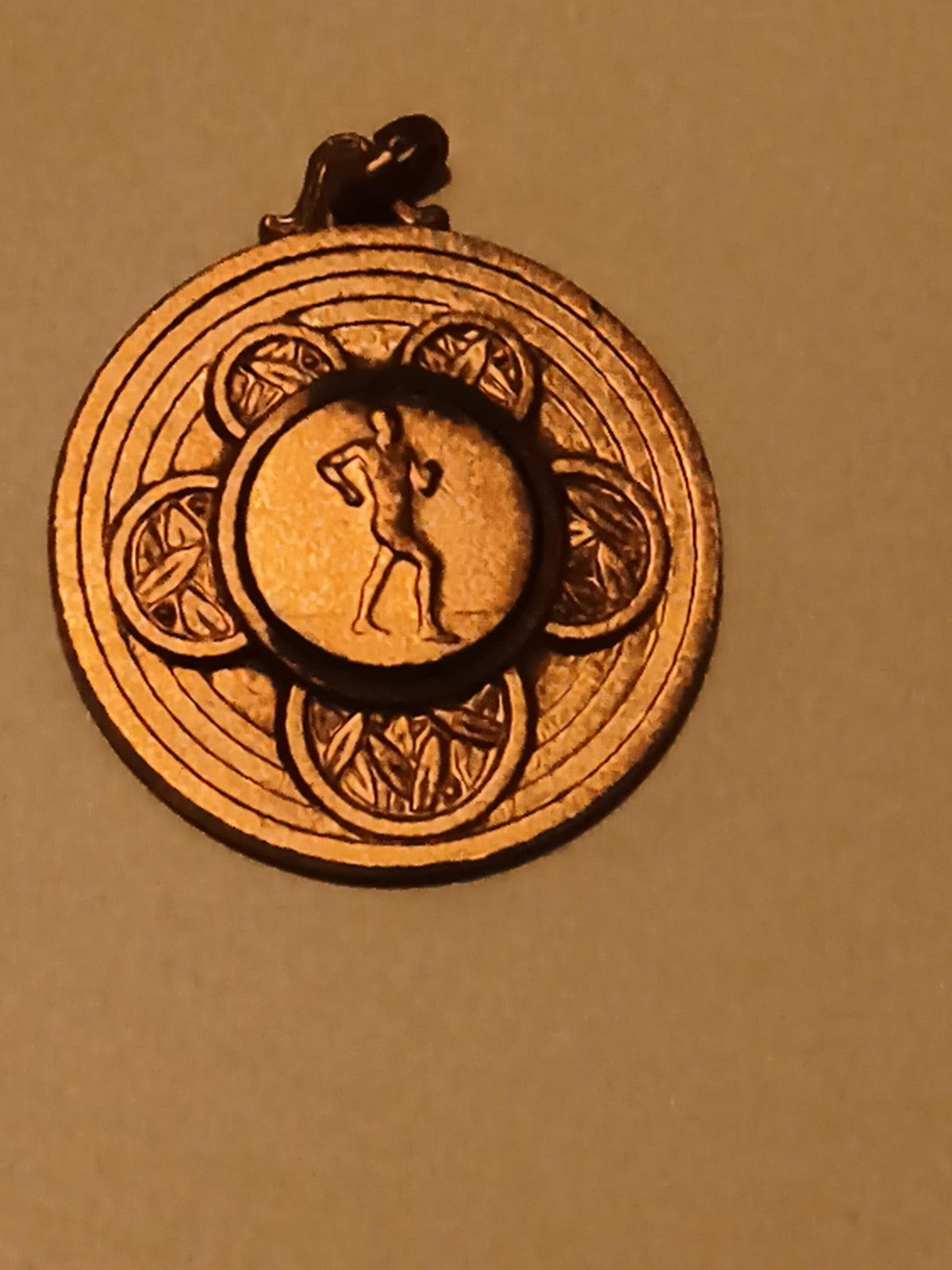 Médaille sport coureur finition dorée, motif laurier, récompense athlétisme