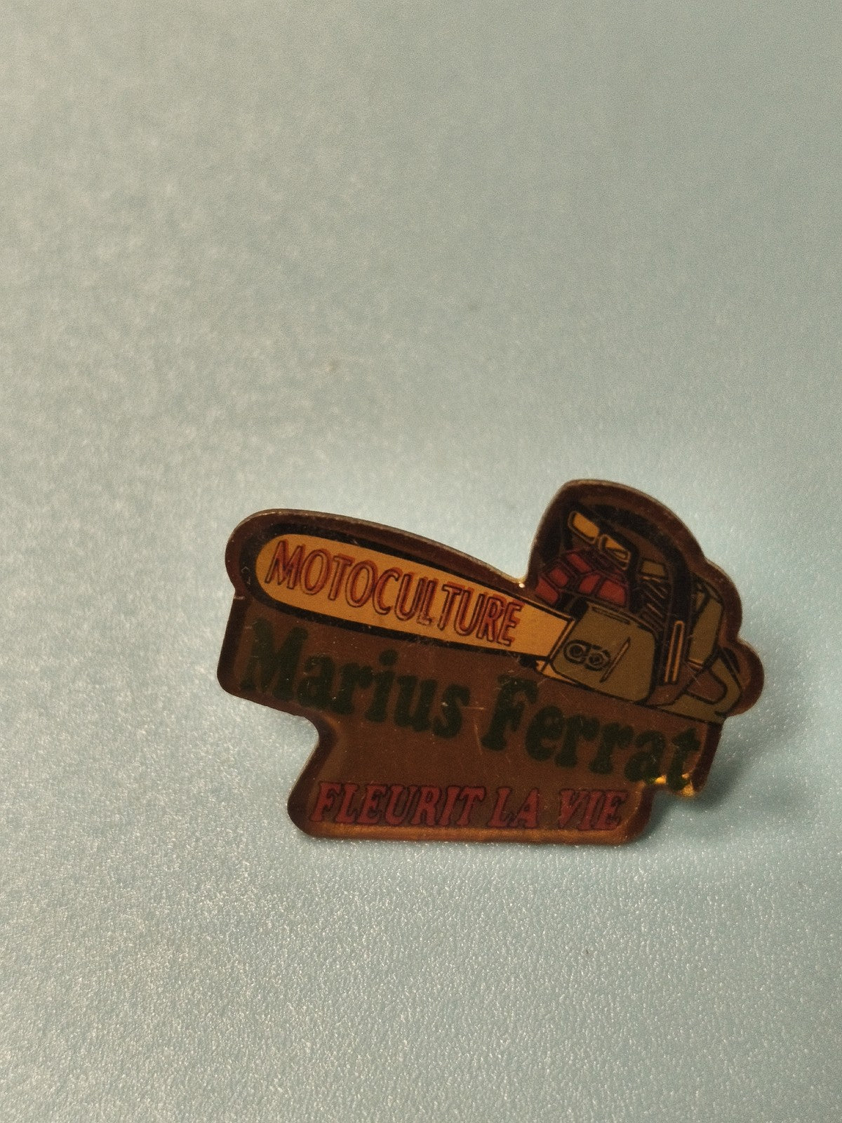 Vintage pin's Marius Ferrat motoculture publicitaire ancien, tronçonneuse