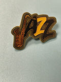 Pin's vintage jazz saxophone émaillé noir jaune ? collection musique rétro