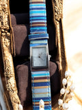 Montre femme vintage Yves Rocher cadran rectangulaire bracelet rayé bleu marron
