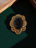 Broche vintage métal doré cabochon noir style baroque rétro
