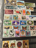 Lot timbres BHOUTAN thèmes fleurs animaux sports papillons couleurs variées