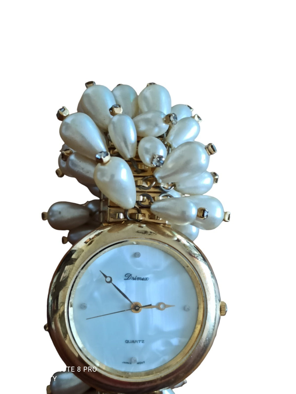 Montre femme Drimex bracelet perles nacrées doré cadran blanc élégant