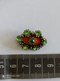 Broche vintage œil orange strass verts style 80s bijou fantaisie rétro