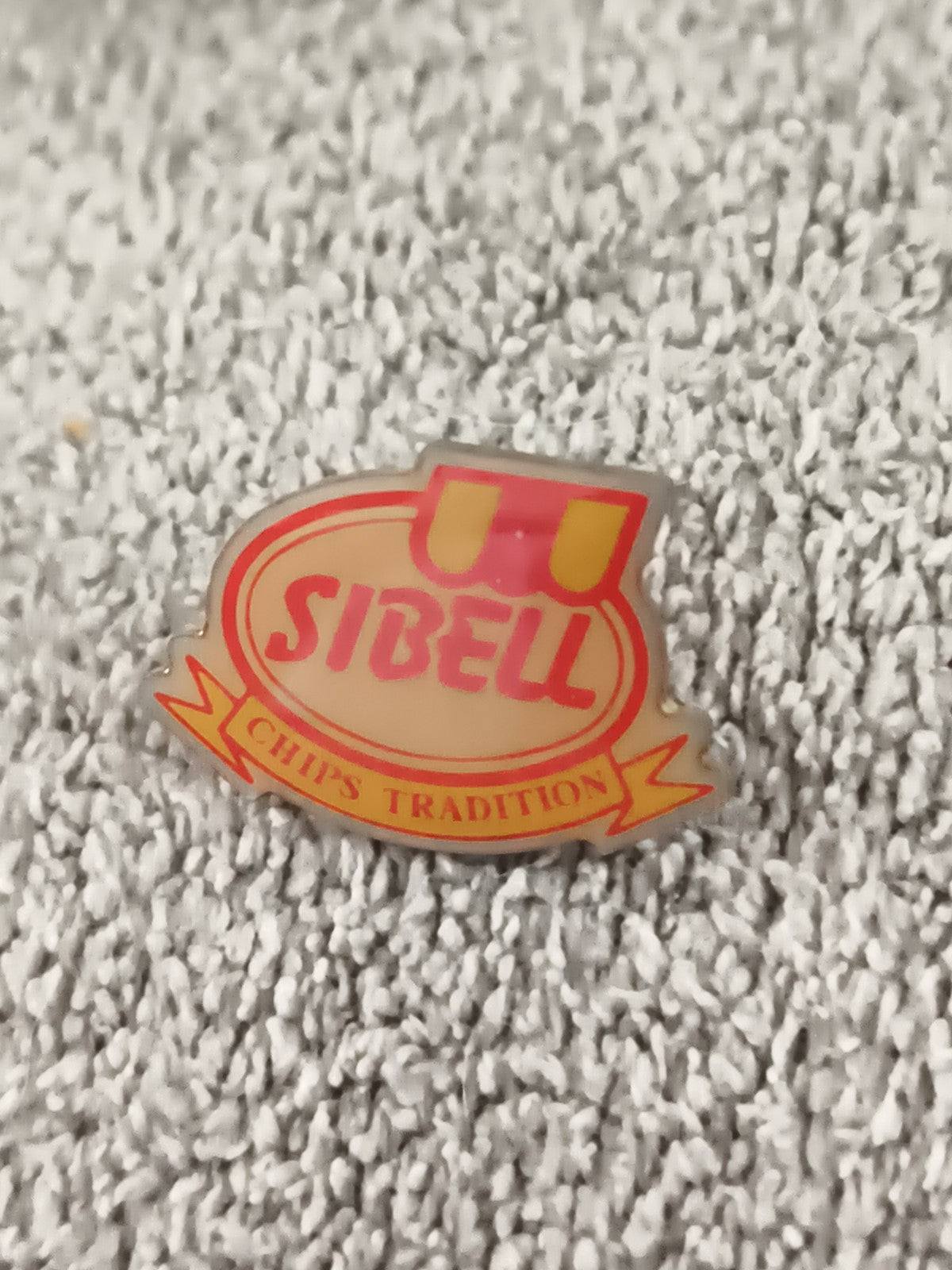 Pin's publicitaire vintage SIBELL Chips Tradition, logo rouge jaune, badge rétro