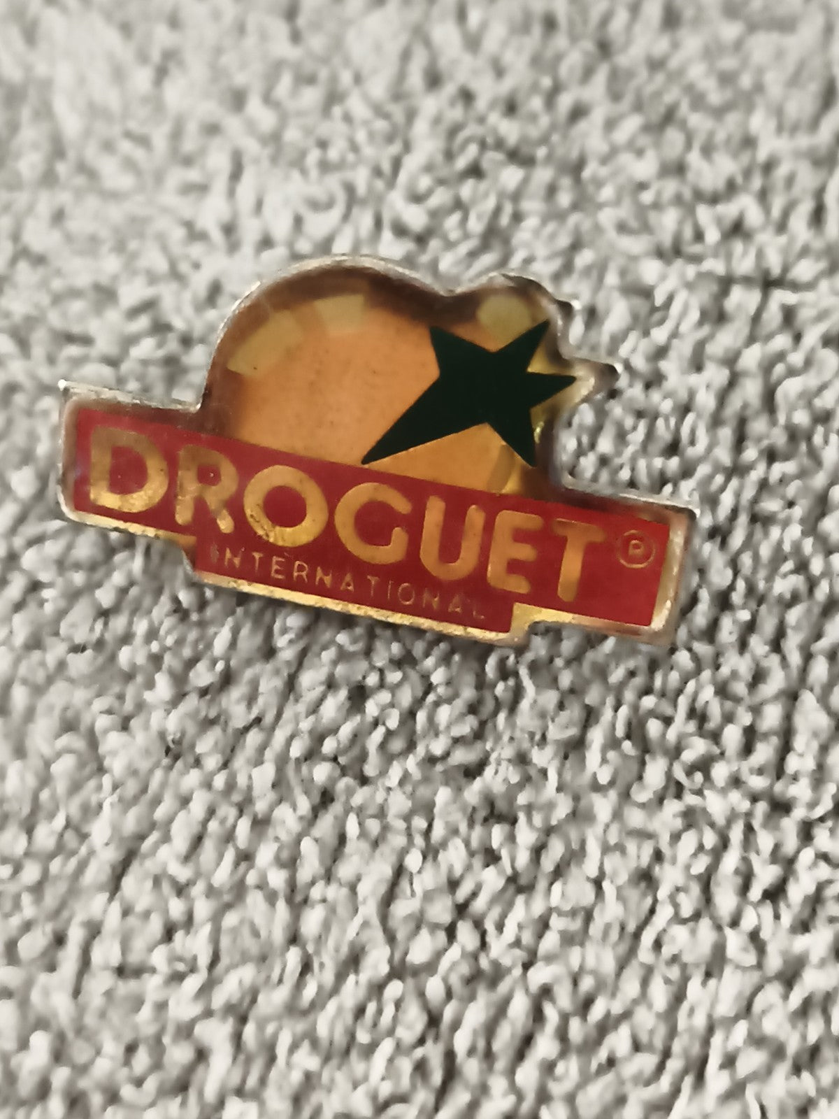 Pin's publicitaire DROGUET International vintage, logo étoile, badge ancien (Ref
