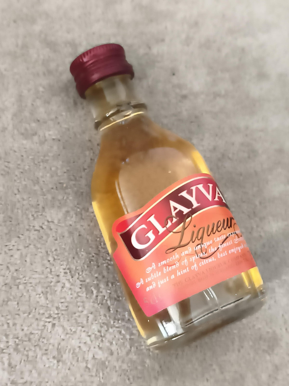 Miniature liqueur GLAYVA bouteille verre partiellement remplie bouchon rouge