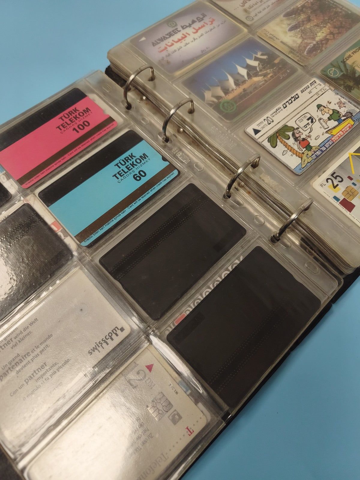 Vintage multi-coloured foreign phone card album collection