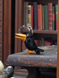Porte-clés vintage Silvestri oiseau noir bec jaune métal rétro publicitaire