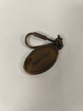 Ancien porte-clés ovale métal patiné Monopole France collection vintage