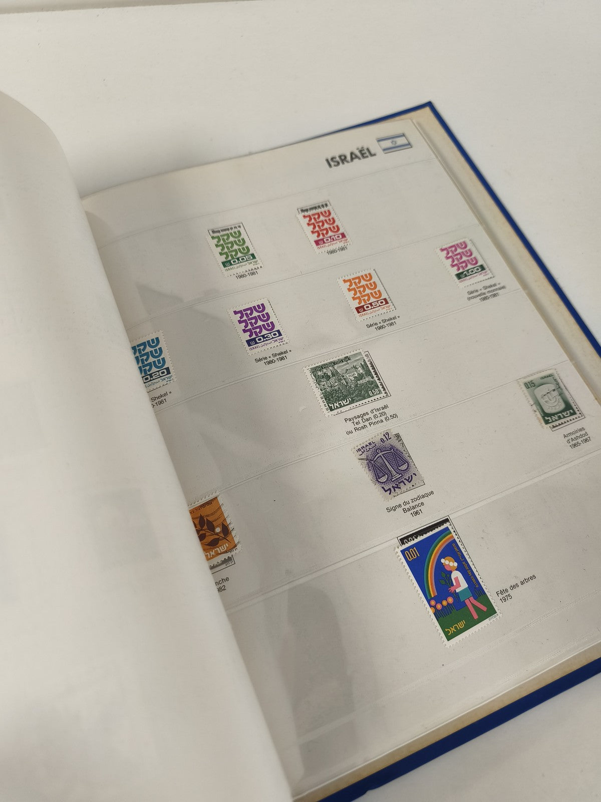 Classeur de timbres partiellement rempli, pages thématiques Japon, reliure bleue