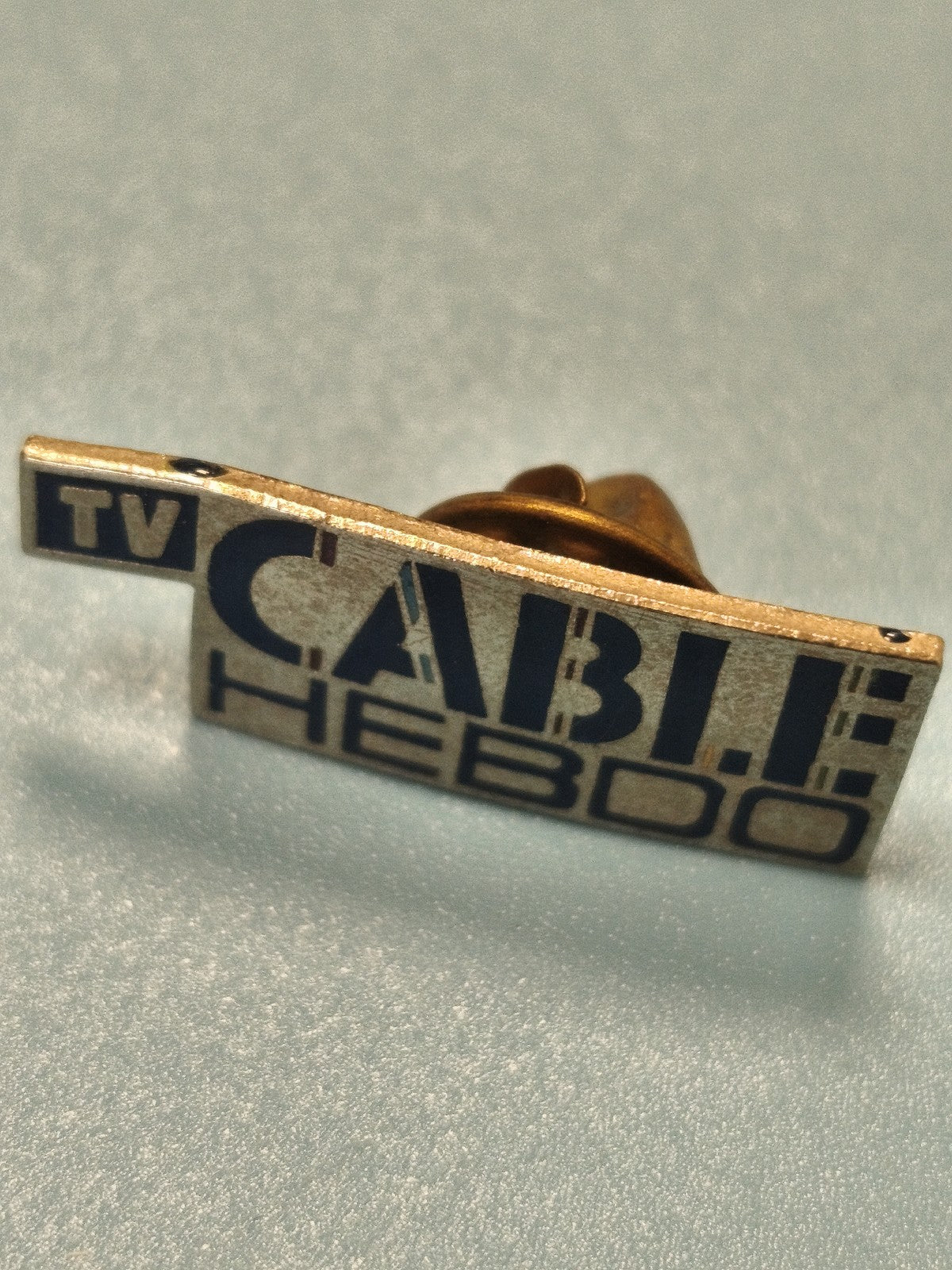 Vintage TV Cable Hebdo rectangular pin, blue and gold colors, collectible