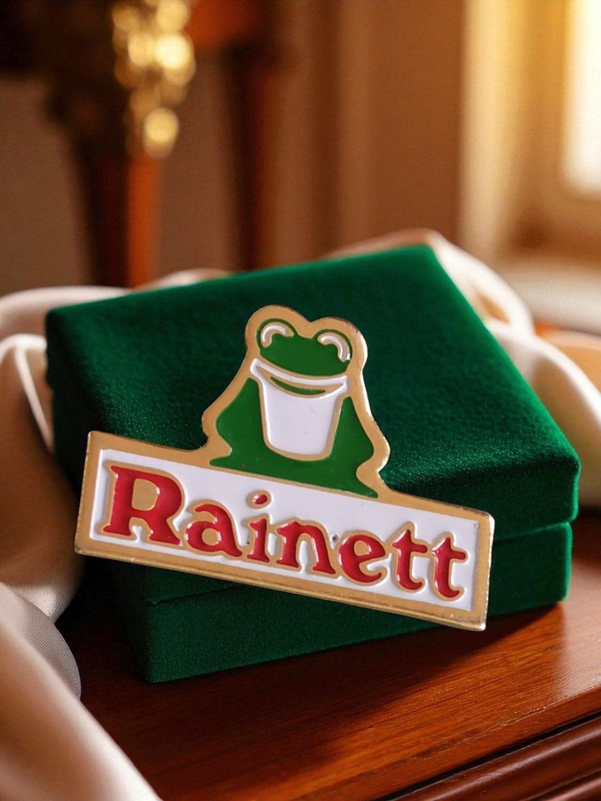 Pin's publicitaire Rainett vintage émail rétro années 80 grenouille logo