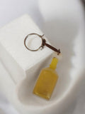 Porte-clés vintage bouteille jaune publicitaire rétro ancien objet d'occasion