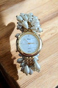 Montre femme Drimex bracelet perles nacrées doré cadran blanc élégant