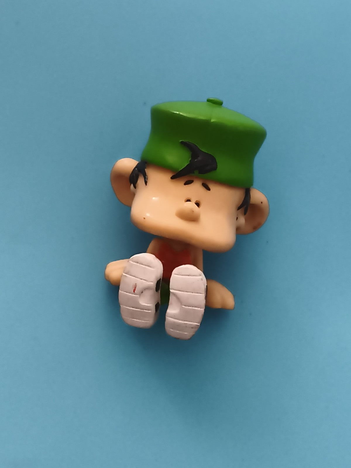 Figurine Kid Paddle assise casquette verte personnage BD jouet déco