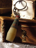 Porte-clés vintage bouteille publicitaire rétro, forme flacon, ancien objet déco