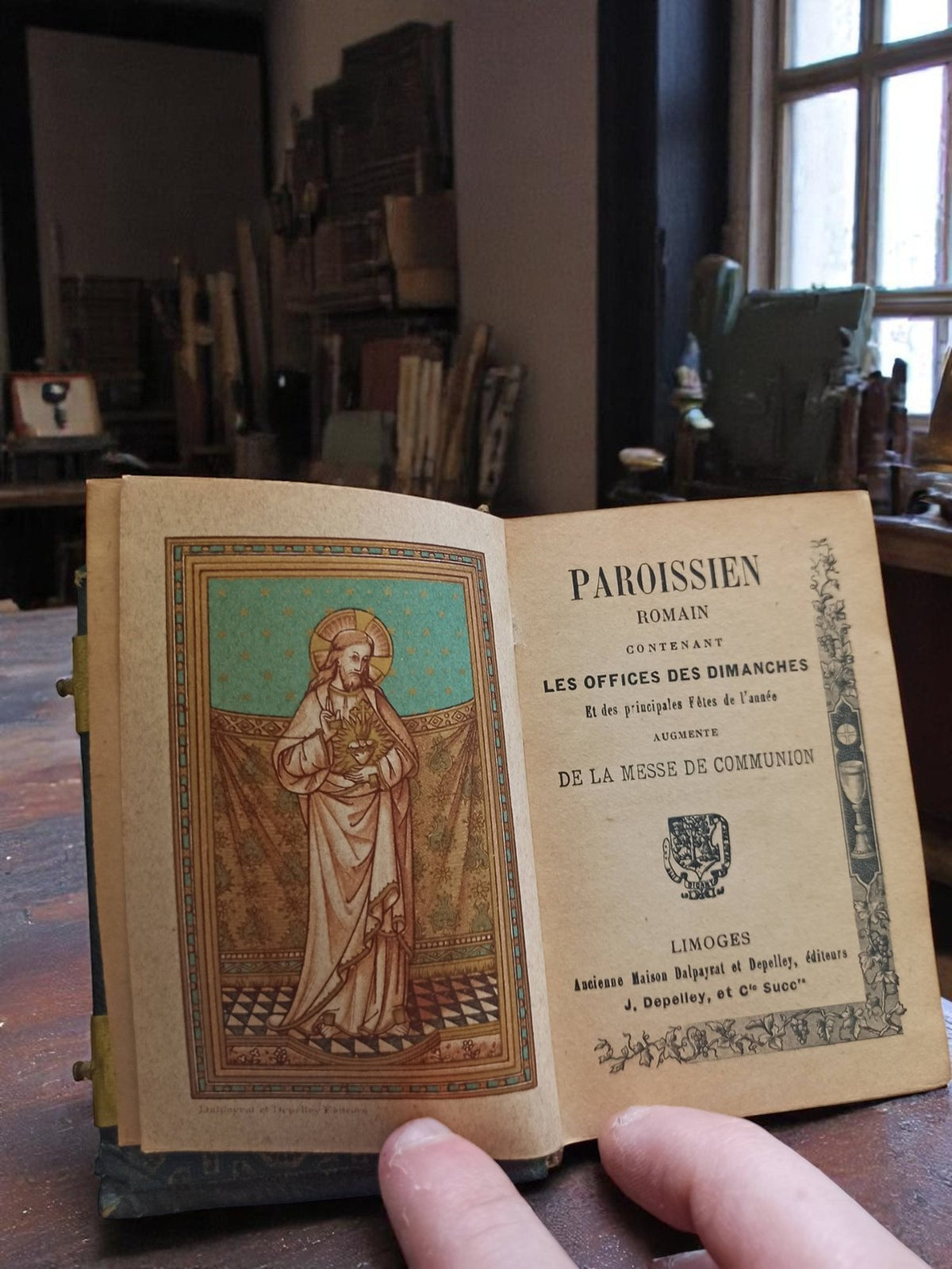 Vintage religious ancient missal in black gilt leather binding with floral decoration