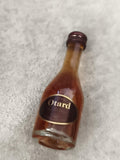 Miniature cognac Otard bouteille verre étiquette noire partiellement remplie