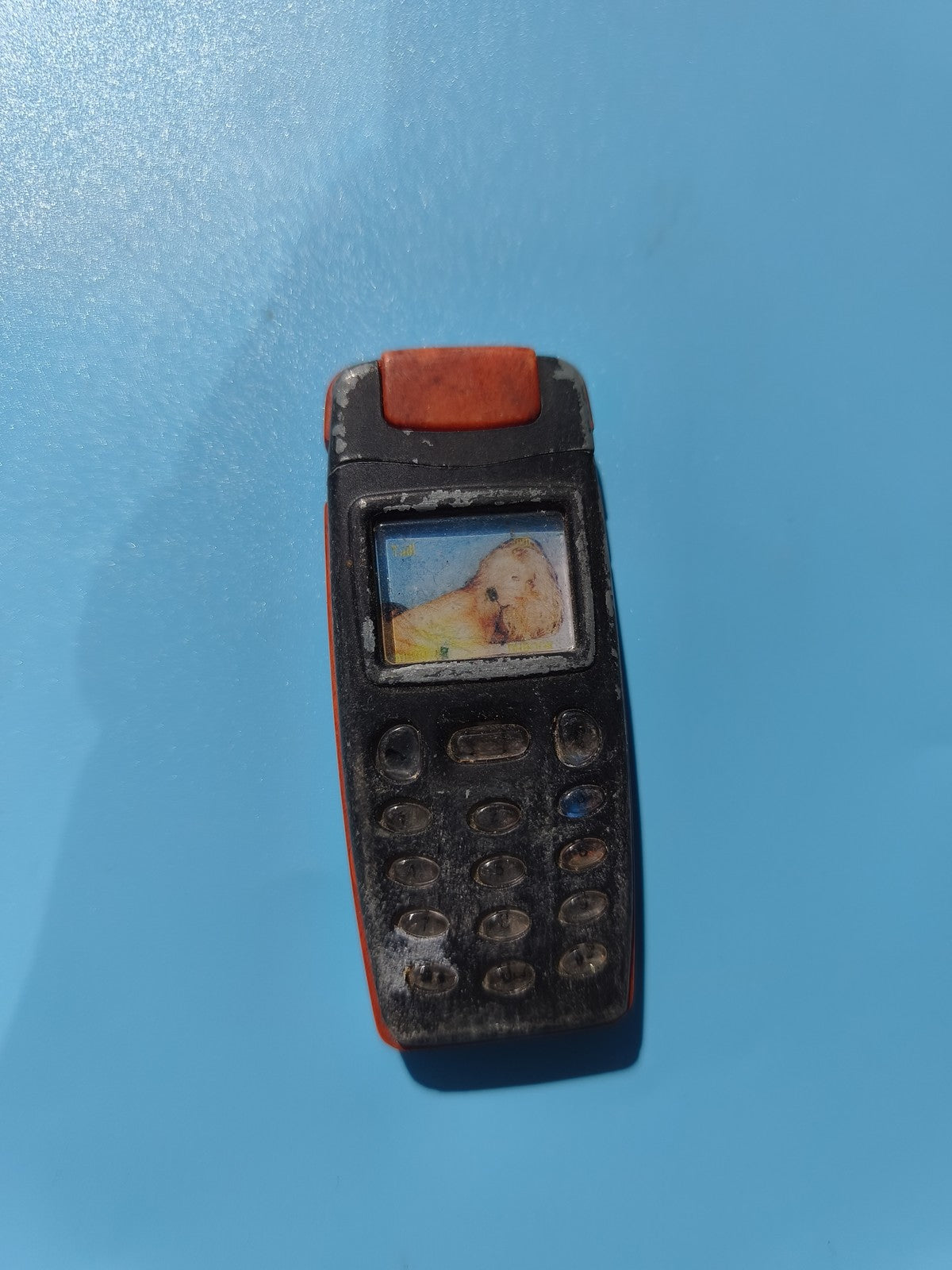 Ancien briquet publicitaire téléphone jouet noir rouge en l'état non testé