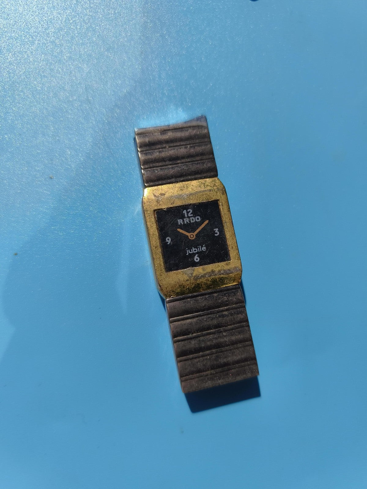 Montre ancienne publicitaire RRDO Jubilé rectangulaire à bracelet métal, à resta