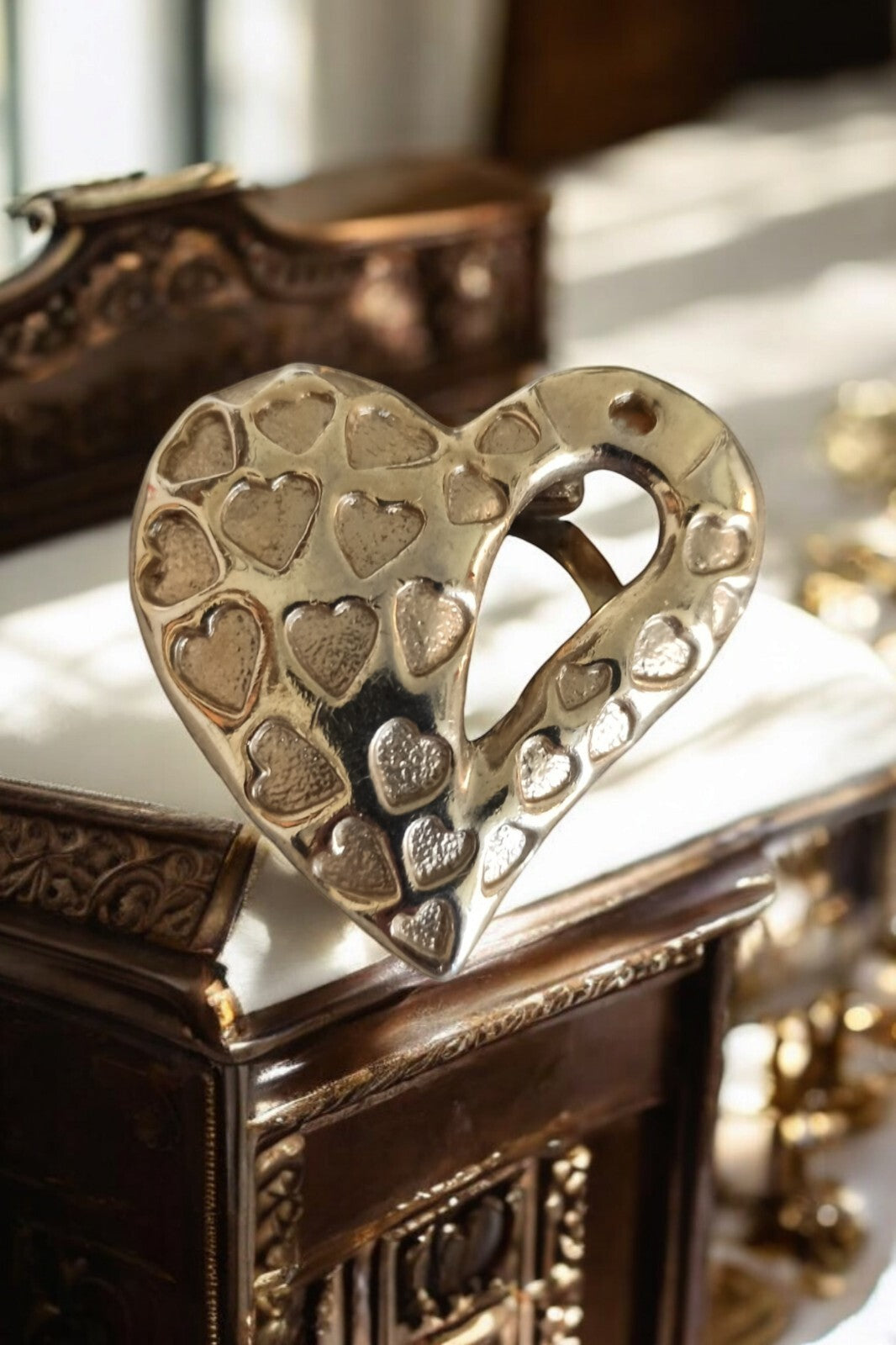 Vintage gold metal heart sculpture with small heart relief decoration, retro decorative item