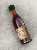 Miniature alcool L'Amour de Poire apéritif bouteille partiellement remplie