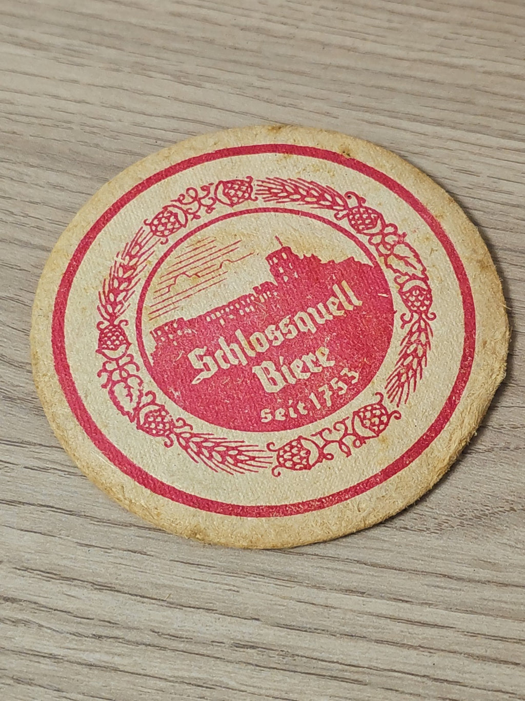 Sous-bock bière Schlossquell d'occasion, dessous de verre publicitaire allemand