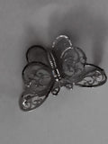 Broche papillon vintage, finition argentée, motif ajouré élégant