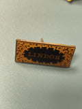 Vintage pin's Lindor rectangulaire noir doré collection publicitaire ancien