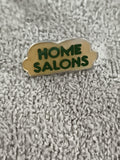Pin's vintage HOME SALONS lettrage vert badge publicitaire (Ref 11)