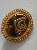 Broche ancienne ovale dorée motif spiralé relief vintage rétro