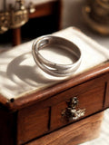Bague vintage créateur, anneau croisé, finition argentée, taille 58