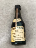 Miniature brandy TORRES 10 Gran Reserva bouteille partiellement remplie