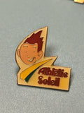 Vintage pin's Athletic Soleil émaillé, personnage cartoon jaune et rouge