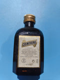 Mignonnette vintage Cointreau ancienne, bouteille ambrée, alcool mi-pleine