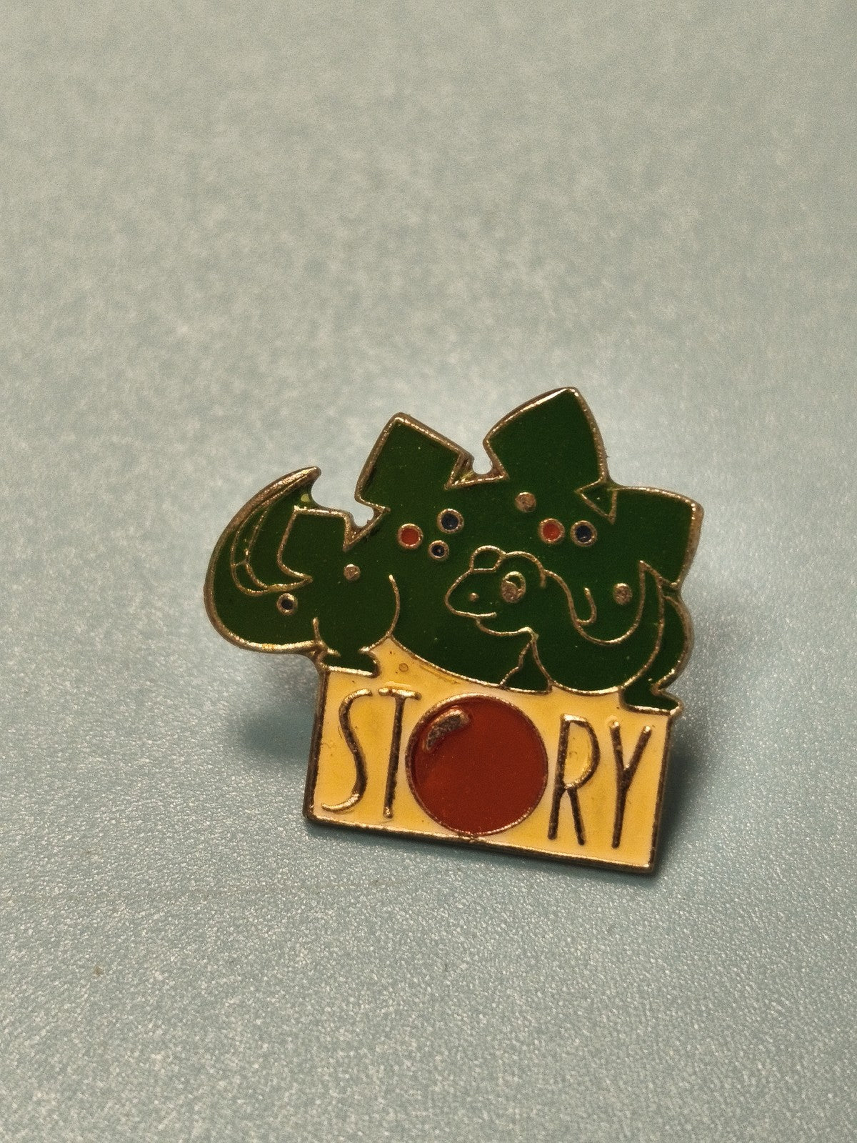 Vintage pin's STORY dinosaure vert émail collection badge original