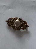 Broche vintage médaillon central perle aspect doré style rétro ancien